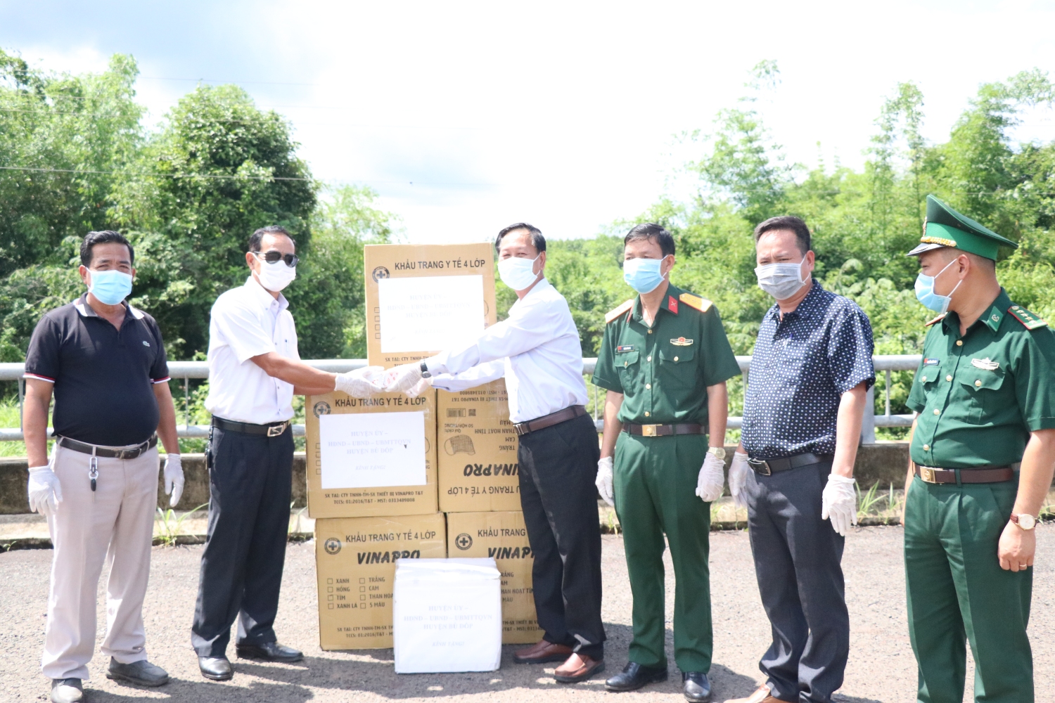 Chủ tịch UBND huyện Bù Đốp Đoàn Văn Thảo trao vật phẩm phòng chống dịch Covid-19 cho lãnh đạo huyện Keosima – Campuchia